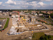 Sunny construction site Kade Zuid part of the new Noorderhaven neighbourhood at river IJssel. Aerial industrial view of building plot. Housing and urban management.