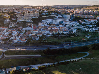 Wall Mural - View of a small district along a busy road at sunset, Cruz Quebrada-Dafundo, Lisbon, Portugal