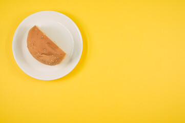 Wall Mural - Top view shot of half bread on a yellow background