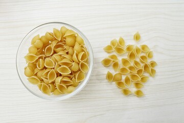 Canvas Print - Italian raw pasta conchiglie rigate macaroni shells Traditional food.