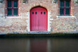 Exterior Of Building With A Red Door Next To A Water Way