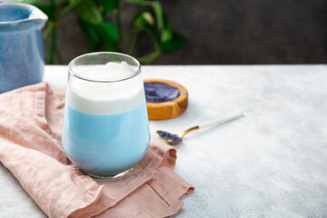 A glass of blue matcha latte, new trendy superfood healthy food, free space for text