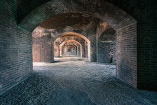 Empty Corridor Of Mysterious Brick Building  With Light Coming Through Arches,