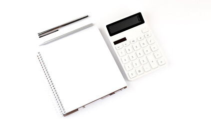 Poster - White notebook with a pencil ,pen and a calculator on a white background