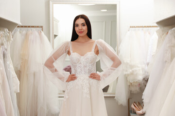 Canvas Print - Woman trying on beautiful wedding dress in boutique