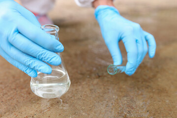 Water samples from river for analysis in flask closeup