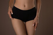 © New Africa - Slim woman with smooth skin in underwear on beige background, closeup. Cellulite problem concept