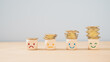 © Ratana21 - emotion face on  stack of coins, saving money, deposit, wealthy, profit, cash for health budget or insurance concept