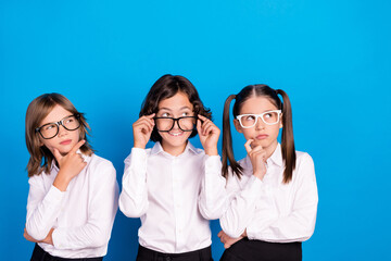 Sticker - Photo of positive minded thoughtful kids look empty space wear school uniform isolated blue color background