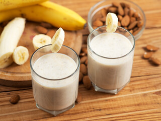 Wall Mural - Milk smoothie cocktail for breakfast with banana, almonds and cinnamon