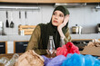© Drobot Dean - Young muslim woman wearing hijab separating waste while sitting at table