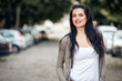 © astrosystem - Young cute female smiling and laughing on the street.