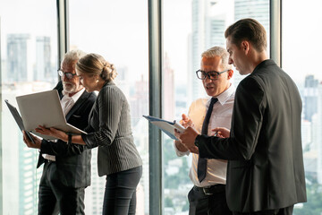 Wall Mural - Group of business People Meeting  in office on window . marketing team Conference Brainstorming. manager man standing and present . Financial Teamwork discussing strategy at workspace on cityscape