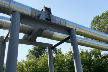 oil and gas industry external pipelines among green trees and lawn, heating main