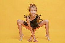 Little Gymnast Performs The Exercise. The Concept Of Sports, Gymnastics, Fitness.