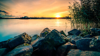 Wall Mural - View of a dutch river from the waterfront during sunrise