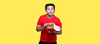 Asian man is eating fried chicken deliciously on Yellow background in studio With copy space.