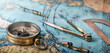 An old geographic map with navigational tools: compass, divider, ruler, protractor. View of the workplace of ship's captain. Travel, geography, navigation, tourism and exploration concept background.