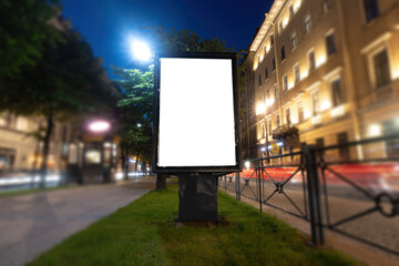 Wall Mural - Billboard for a poster on the background of the city at night. Vertical billboard mock-up.