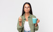 © kues1 - young hispanic woman making capice or money gesture, telling you to pay and holding a coffee mug