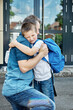 © Elena Medoks - Back to school. Dad sees off, hugs the child before the start of lessons. The new school year. Caring, parent-child relationship