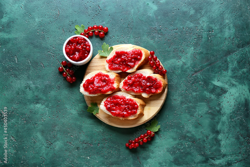 Tasty sandwiches with red currant jam on color background