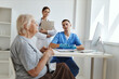 © SHOTPRIME STUDIO - an elderly woman at a doctor's appointment and a nurse in a hospital office