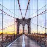 Fototapeta Mosty linowy / wiszący - Symmetrical shot of the Brooklyn bridge at dawn