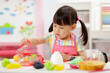 © M-image - young  girl pretend play food preparing at home