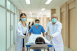© godji10 - Doctor and male nurse moving injured patient on a gurney