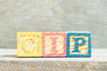 Sticker - Color alphabet letter block in word CIP (Abbreviation of Carriage and Insurance Paid to, Continual improvement process or Clean-in-place) on wood background