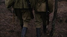 Two Soldiers Of World War Ii Walking In A Forest With Rifles And Helmets And Boots