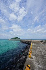 a wonderful seascape with emerald green water and charming clouds