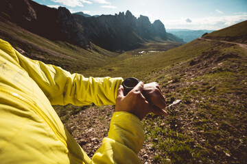 Wall Mural - Woman on high altitude mountain top checking the altimeter on the sports watch