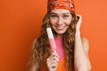 Poster - Young ginger woman in bandana smiling while posing with ice cream