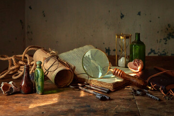 Medicines and substances in glass bottles on an old wooden table. A medieval scientist's room with various flasks and old books.