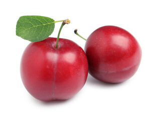 Delicious ripe cherry plums with leaf on white background