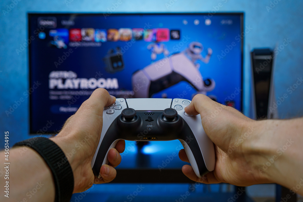 Console Player Sony PlayStation 5. New generation gaming computer. PS5 controller. Man ...