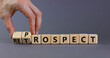 Prospect or retrospect symbol. Businessman turns wooden cubes and changes the word 'retrospect' to 'prospect'. Beautiful grey background. Business and prospect or retrospect concept. Copy space.