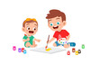 cute little boy drawing together with baby sibling
