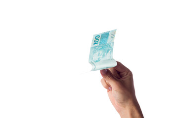 man holding hundred reais bills isolated on white. Brazilian money