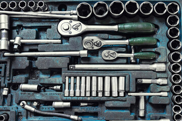 Above view of used greasy old dirty car repair mechanic hand tool set kit vehicle repair and maintencae service. Hardware toolkit with many different garage equipment. Automobile fix background