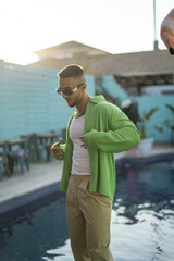 Wall Mural - Vertical shot of an attractive young Spanish bearded male posing in stylish clothes