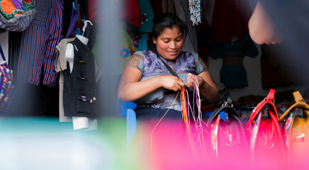 woman who uses her hands to make traditional fabrics. Mexican mecicana merchant works.