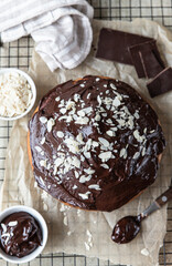 Wall Mural - Homemade chocolate and vanilla cake decorated with chocolate glaze and nuts on black metal grille. Marble cake.