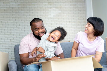 African American family,  father, Asian mother and 5-year-old daughter, they are happy together From moving or relocation to a new home, to black skin family and relocation concept.