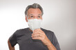 © Marcos - Man trying to Drink Water while still wearing his Surgical Mask