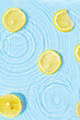 Abstract water texture with wet lemon slices, surface with drops, rings
