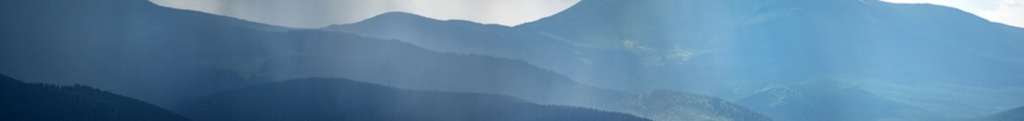 Wall Mural - sun rays and rain in the carpathian mountains in summer