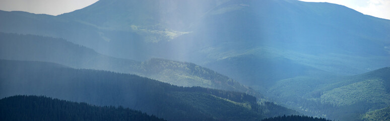 Wall Mural - sun rays and rain in the carpathian mountains in summer